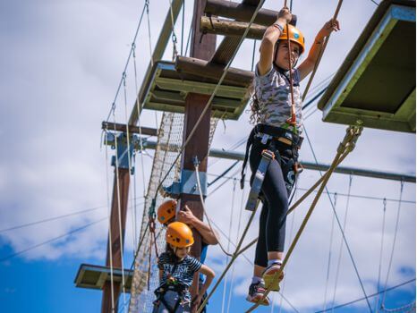 Escolares realizando la tirolina y escalada en rocódromo